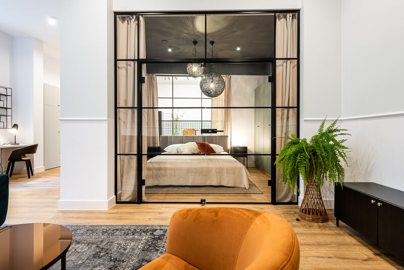 Glass-walled bedroom in a 1-bedroom apartment