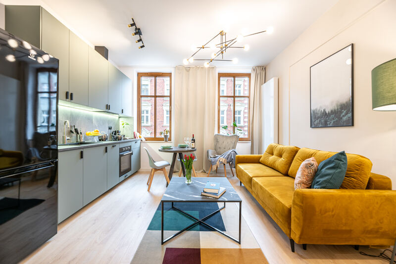 Kitchen and living area with yellow sofa